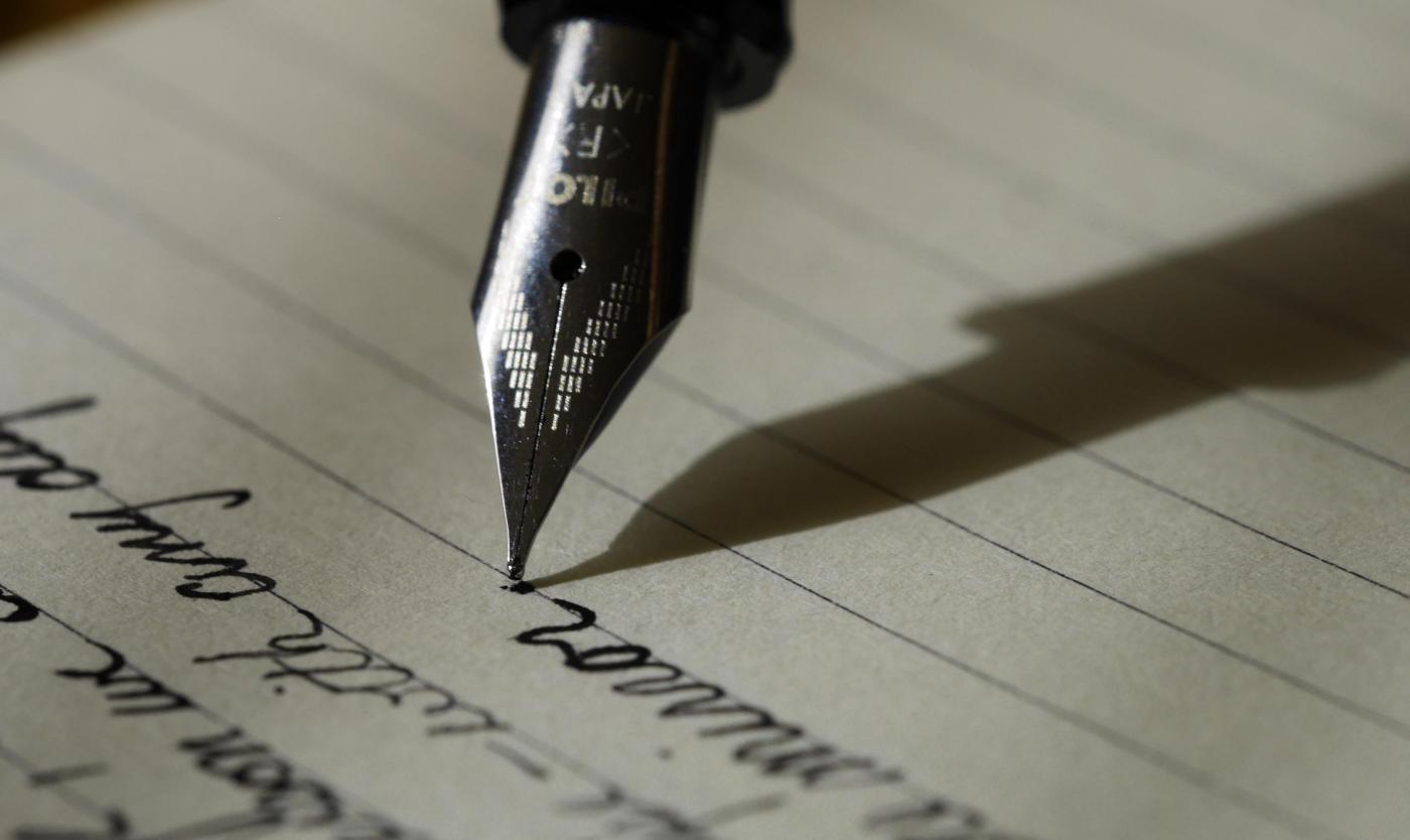 Fountain pen on black lined paper