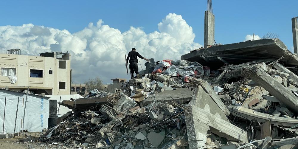 A man from Gaza standing on the rubble of houses destroyed in Gaza war 
